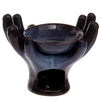 Angled view of an open hands ceramic oil burner in a dark blue, mottled glazed finish, with a central bowl and a tea light opening at the front.