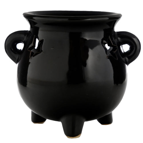 Full, slightly angled view of a glossy black cauldron oil burner, featuring star-shaped cut-outs near the two loop handles and standing on three feet.