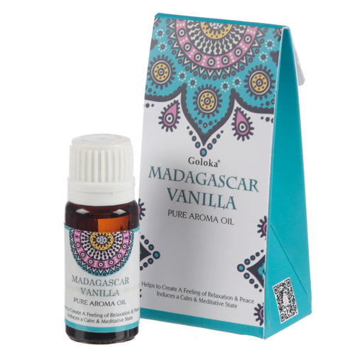 Angled view of a dark amber aroma oil bottle with a white ridged cap, and its teal and white packaging box. Both feature a colourful, intricate mandala-style pattern and display the text 'Madagascar Vanilla Pure Aroma Oil'.
