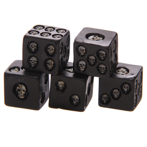 Angled view of a pack of five black skull dice, featuring debossed skull designs on each face instead of pips, presented on a white background.