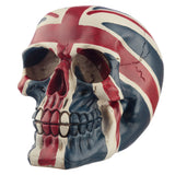 Angled view of a Union Flag skull decoration, featuring red, white, and blue paintwork with aged, crackled details, and visible teeth.