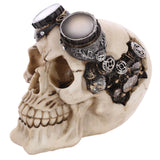 Angled view of a bone-coloured steampunk skull decoration with metallic goggles, featuring intricate gears and cogs embedded on the side of its head.