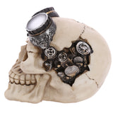 Steampunk style skull decoration with goggles, angled view showing intricate silver and bronze gears on the right side of the cream-coloured skull.