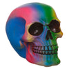 Angled view of a Rainbow Skull Decoration ornament, showcasing its vibrant gradient of blue, pink, green, and yellow colours, with distinct eye sockets and teeth.