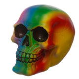 Angled view of a rainbow skull decoration, featuring vibrant rainbow colours, hollow eye sockets, and visible teeth.