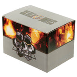 Angled view of a grey product packaging box for a skull-themed item, featuring SKULL & BONES text on the top and a graphic of skulls within a hexagonal design against a fiery orange and red background on the front and side. The side also displays SKULL ORNAMENT.