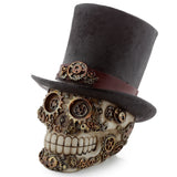 Angled view of a cream steampunk skull figurine with a textured black top hat and reddish-brown band, intricately adorned with bronze and gold-toned gears and cogs.