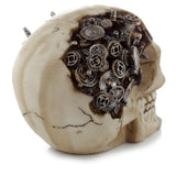 Angled view of an aged cream-coloured Steampunk Style Skull ornament, with intricate dark metallic cogs and gears embedded in its cranium.