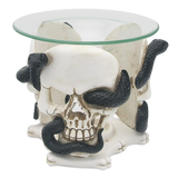 Front view of a cream-coloured skull and black serpent resin oil and wax burner with a clear glass dish.
