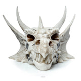 Front view of a bone-coloured dragon skull decoration with intricate carvings, metallic accents, and prominent horns.