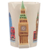 Close-up view of a cream ceramic mug, prominently featuring its sculpted Big Ben shaped handle with a visible clock face and green roof detail. The mug's body is decorated with illustrations of other London icons, including a red double-decker bus and a red telephone box.