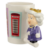 Angled view of a white ceramic mug with a sculpted handle depicting Queen Elizabeth II wearing a purple dress and gold crown, and a red telephone box illustration on its side.