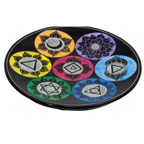 Oval black soapstone chakra incense burner dish, showcasing seven vibrant chakra symbols in orange, purple, yellow, red, light blue, green, and dark blue.