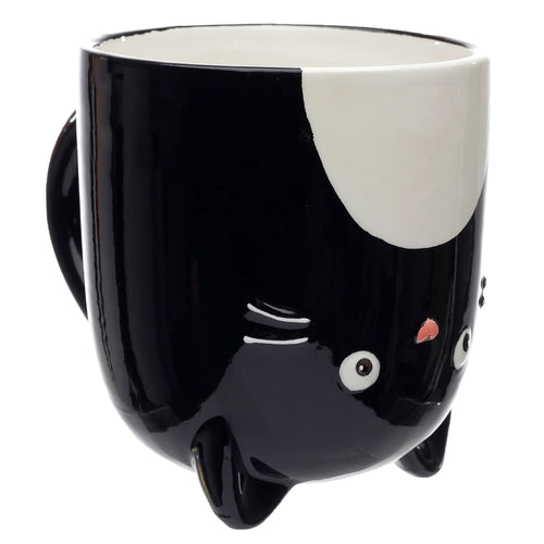 Front view of a black ceramic cat shaped upside down mug, featuring white eyes, a pink nose, and whiskers on its base.