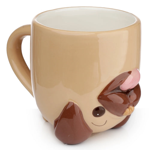 Angled view of a beige ceramic upside down mug, showcasing the dark brown pug face with white eyes, pink tongue, and a smiling mouth on its base.