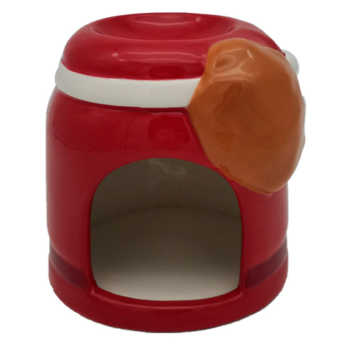 Angled view of a Santa-shaped Christmas ceramic oil burner, with a glossy red body, a white band, and a prominent orange-brown feature. It has a recessed oil dish on top and an arched opening at the base.
