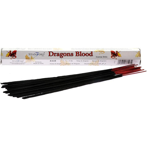Angled front view of a white Stamford Dragons Blood incense stick box, featuring dragon illustrations, with a bundle of black incense sticks with red tips laid in front.
