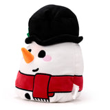 Angled view of a white plush snowman toy, featuring a black top hat with a small green leaf detail, an orange carrot nose, black embroidered eyes and mouth, pink rosy cheeks, and a red scarf with black button details on its body.