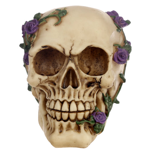 Front view of a bone-coloured gothic skull decoration, intricately adorned with vibrant purple roses and green trailing vines.