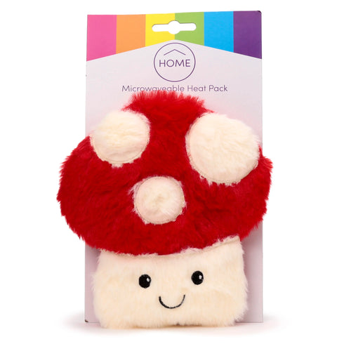 Front view of a plush red and cream mushroom toadstool microwavable heat pack featuring a smiling face and fluffy cream spots, presented on white and rainbow-coloured retail packaging.