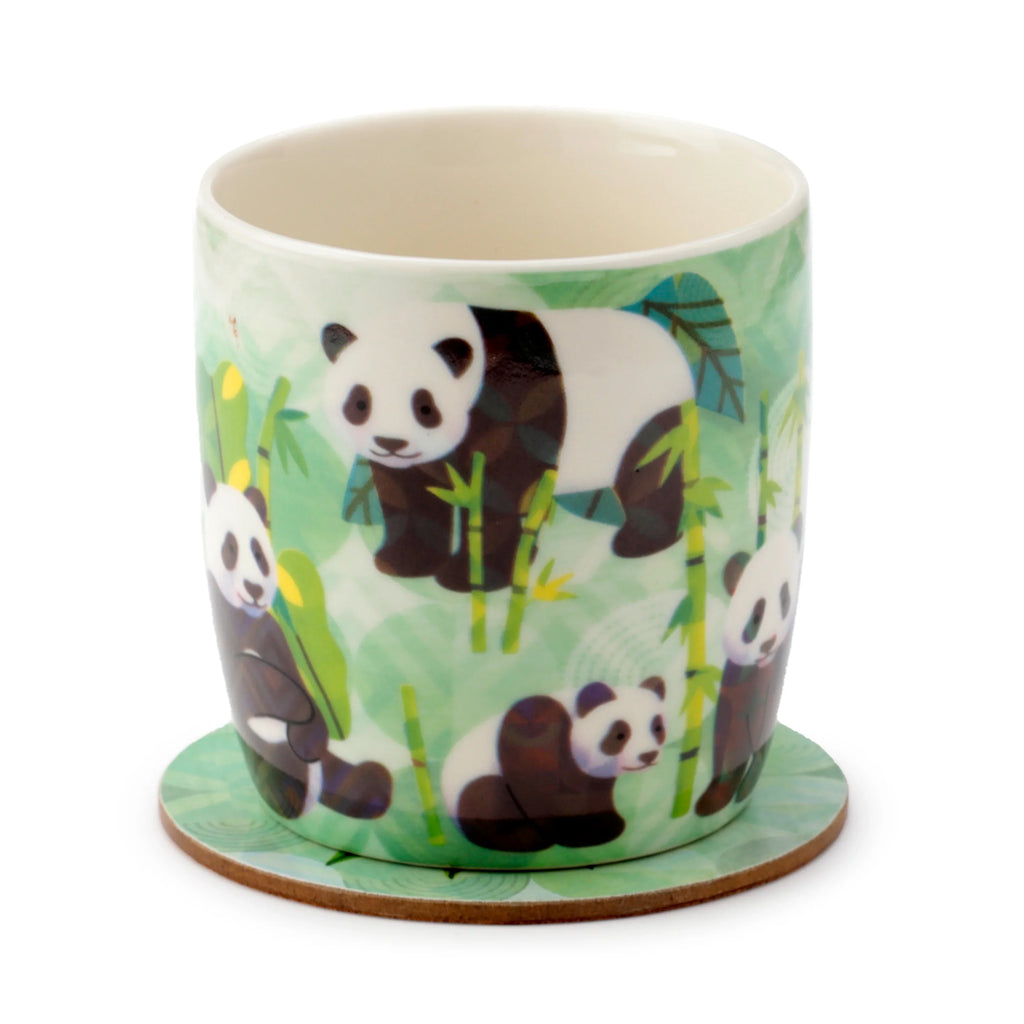 Angled view of a porcelain mug featuring a green and white panda and bamboo design, with a matching coaster, set against a white background.