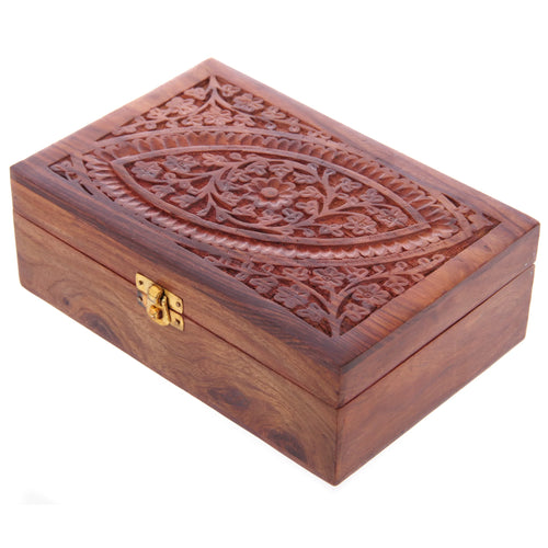 Angled view of a decorative Sheesham wood trinket box, featuring an intricately carved floral pattern on its lid and a brass clasp.