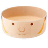 Angled view of a round cream bento lunch box container, decorated with a brown and yellow cartoon guardsman face design.