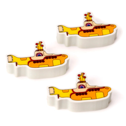 Angled view of three Yellow Submarine erasers, each displaying yellow, orange, and red detailing on a white base.