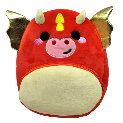 Front view of a plush red and cream kids dragon backpack, featuring gold wings, light green horns, and an embroidered dragon face.
