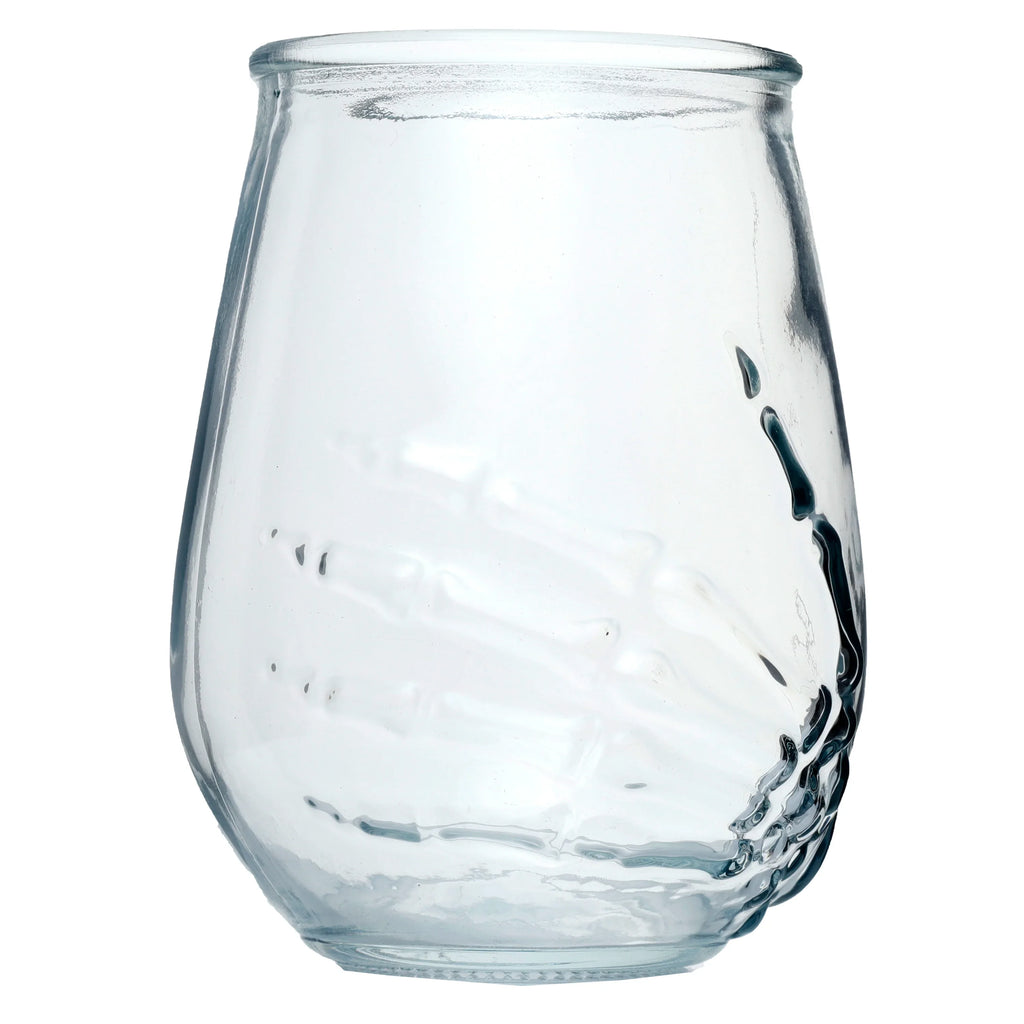 Angled view of a clear glass tumbler featuring an embossed skeleton hand design.