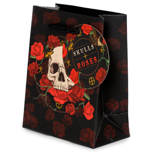 Front view of a black small gift bag with Skulls and Roses red rose design, featuring a central skull and a round 'SKULLS + ROSES' tag.