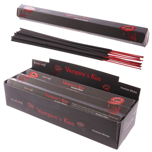 Angled view of black incense sticks with red tips, displayed with an open individual 'Vampire's Kiss' box and a large retail display box filled with more packs. All packaging features red vampire lips graphics.