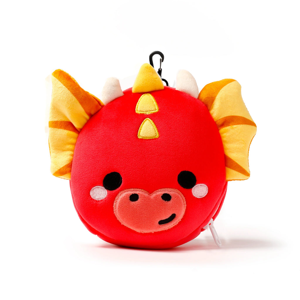 Front view of a red plush dragon travel pillow and eye mask, featuring yellow wings, small white horns, yellow head spikes, and an embroidered friendly face.