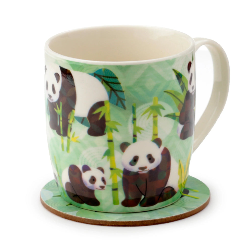 Angled view of a white and green porcelain mug with a cartoon panda family and bamboo design, sitting on a matching round green coaster. The mug's cream-coloured interior and handle are visible.