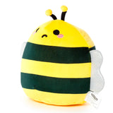 Angled view of a soft, cuddly yellow and dark green striped bee plush toy, featuring black antennae, embroidered eyes with a winking mouth, pink cheeks, and sparkly white wings, on a white background.