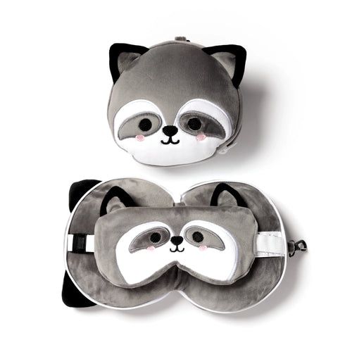 Overhead view of a grey raccoon plush travel pillow and eye mask set. One pillow is shown zipped as a round raccoon head, and the other unzipped to form a U-shaped neck pillow with a matching raccoon eye mask inside.
