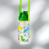 Angled view of a clear children's water bottle, featuring a bright green lid, pop-up white straw, and an all-over colourful dinosaur pattern, suspended by a green strap.