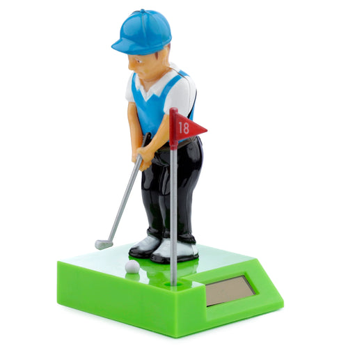 Angled product view of a Collectable Golfer Solar Powered Pal, featuring a golfer figurine in a blue cap and vest, holding a golf club over a white ball. The bright green base includes a red flag with '18' and a visible rectangular solar panel.