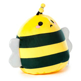Angled view of a yellow and dark green striped bee plush toy, showing its embroidered face with black eyes, mouth, and pink blush, black antennae with yellow tips, and sparkly silver wings.
