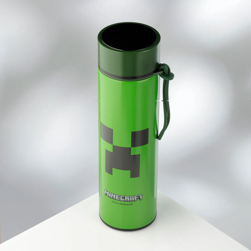 Front view of a lime green stainless steel insulated drinks bottle, featuring a black pixelated Minecraft Creeper face design and Minecraft logo, with a dark green top section and carrying strap.