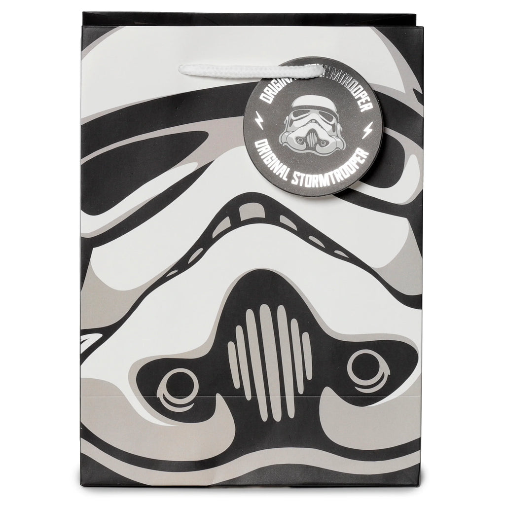Front view of a medium gift bag in black, white, and gray, featuring a Stormtrooper helmet design, with a white rope handle and a circular tag displaying Original Stormtrooper text.