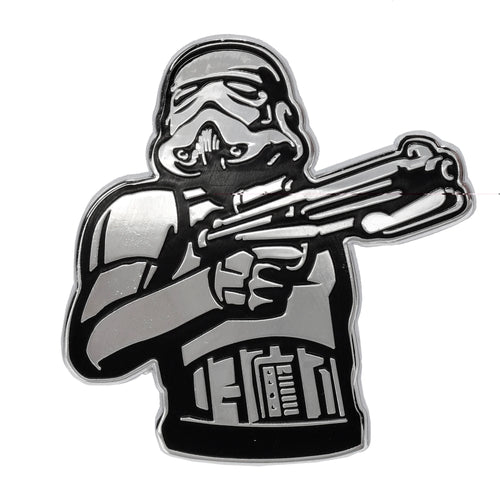 Front view of a black and silver Stormtrooper enamel pin badge, depicting the character from the chest up holding a blaster rifle.