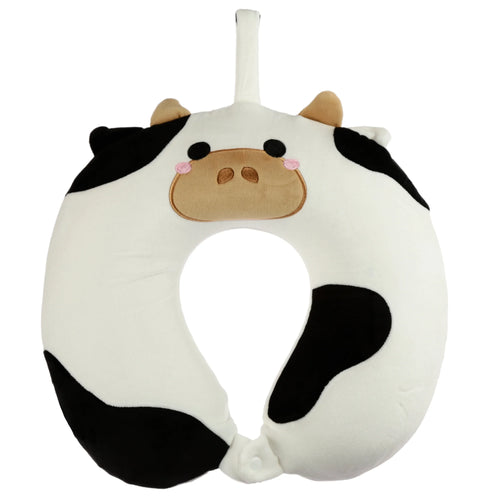 Front view of a white and black cow plush memory foam travel pillow, with embroidered black eyes, a brown snout, pink cheeks, light brown ears, a white hanging loop at the top, and a white snap closure at the bottom.