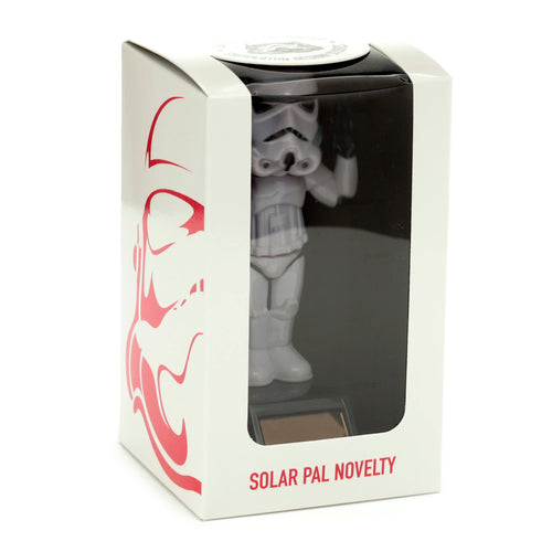 Front view of a Collectable The Original Stormtrooper Peace Solar Powered Pal, a white Stormtrooper figurine, displayed in its white box packaging with a clear front window. The box features red stylized Stormtrooper helmet graphics and SOLAR PAL NOVELTY text, with the figurine's solar panel base visible.
