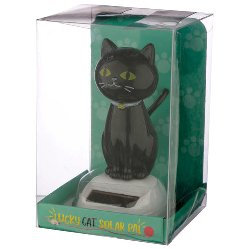 Front view of a Collectable Lucky Black Cat Solar Powered Pal figurine in clear box packaging with a green paw print background. The black cat features bright yellow eyes, white whiskers, a yellow collar bell, and a visible solar panel on its white base.