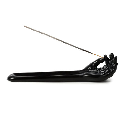 Front-side view of a black decorative hand-shaped incense ashcatcher with white palmistry markings, holding an incense stick.