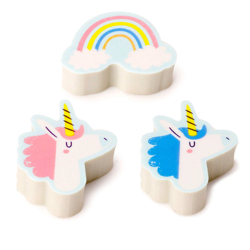 Three-piece eraser set, angled view from above, with one rainbow eraser featuring colourful arcs, and two unicorn head erasers, one with a pink mane and one with a blue mane.