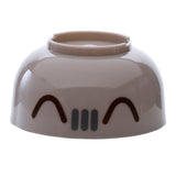 Angled view of a taupe round bento lunch box section with a black Pusheen the Cat face design.