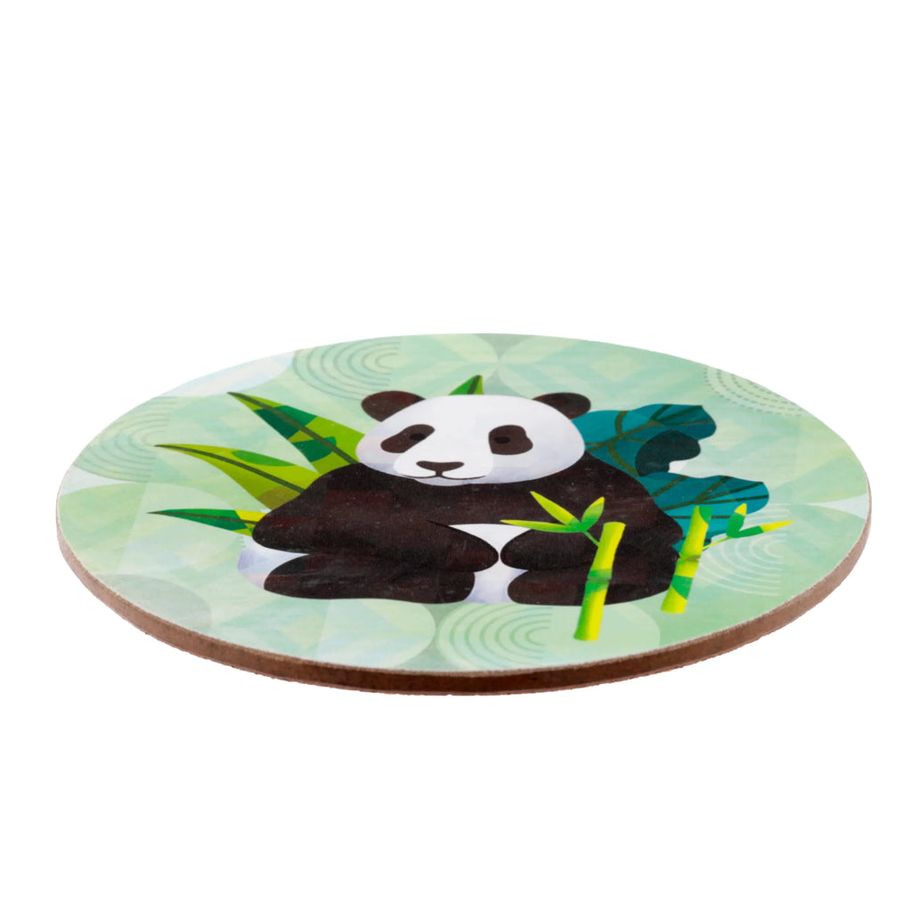 Angled view of a round coaster, featuring a black and white panda illustration surrounded by green bamboo and leaves on a light green patterned background, with a visible brown side edge.