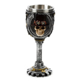 Front view of a decorative steampunk goblet featuring a skull wearing a top hat and goggles, with a threaded bolt stem and a gear-shaped base, finished in metallic grey and gold colours.